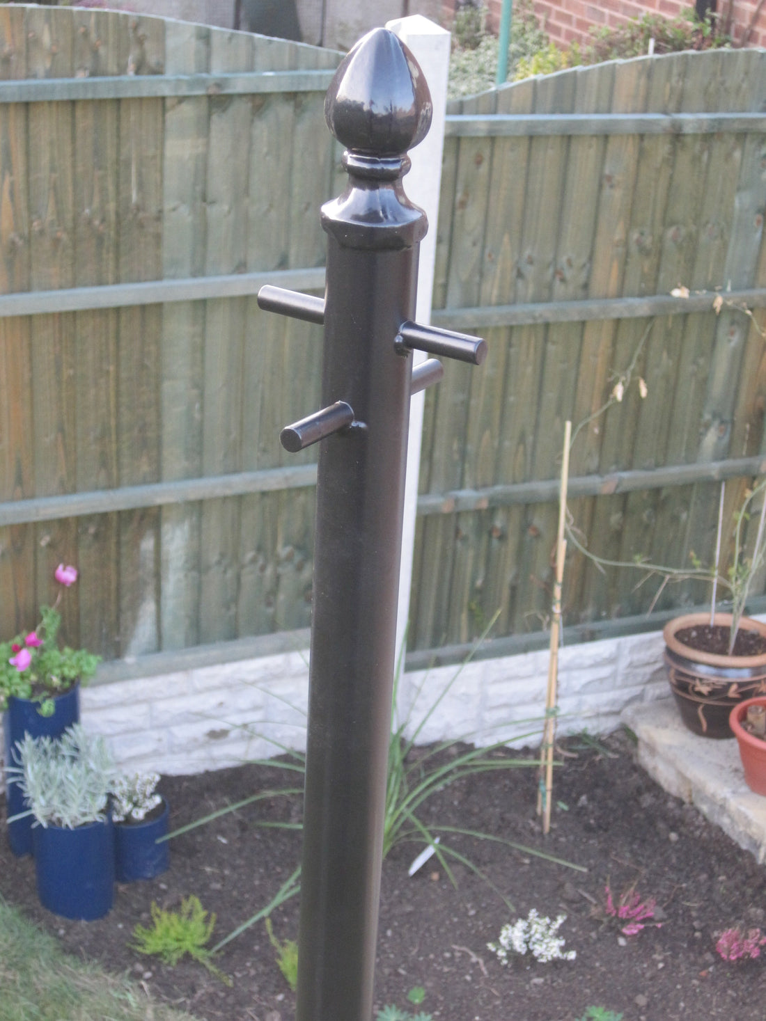 Washing line pole installed in a UK garden – How Long Does Washing Take to Dry Outside in the UK?