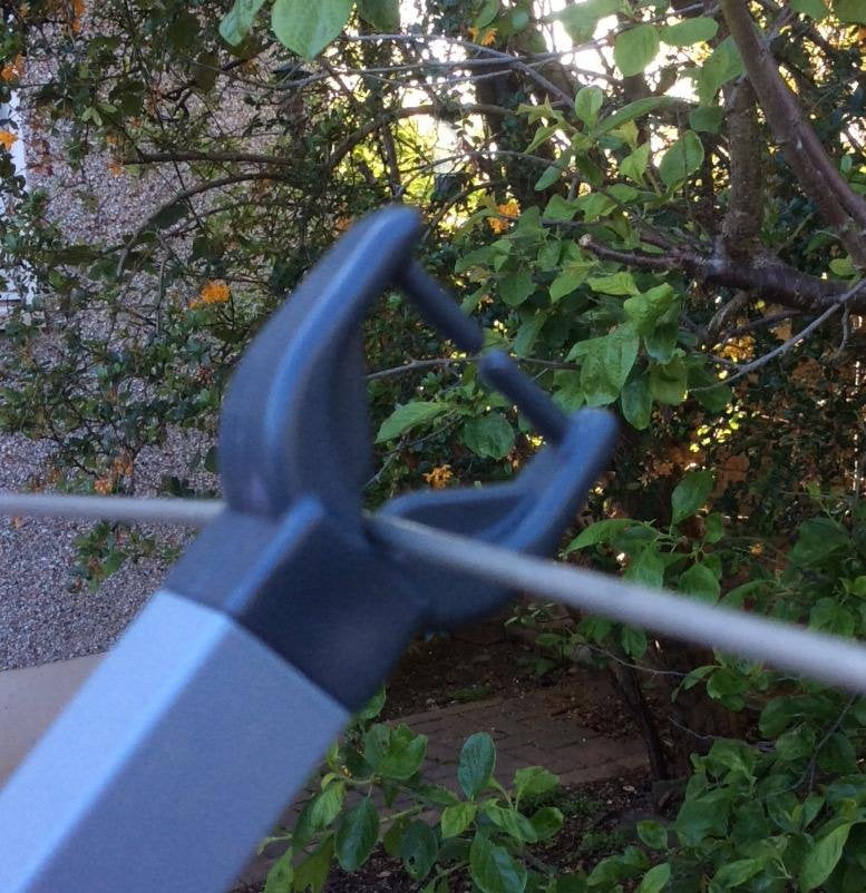 Metal clothes line prop supporting a washing line – Scottish Washing Posts