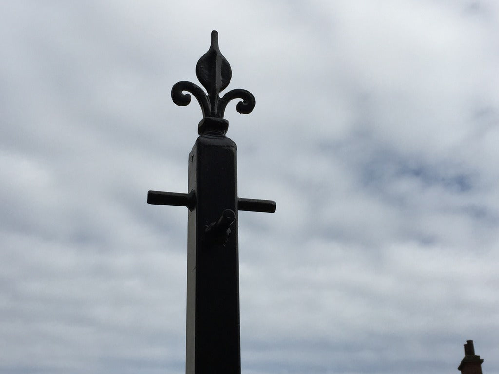 Black powder-coated washing line pole in a garden