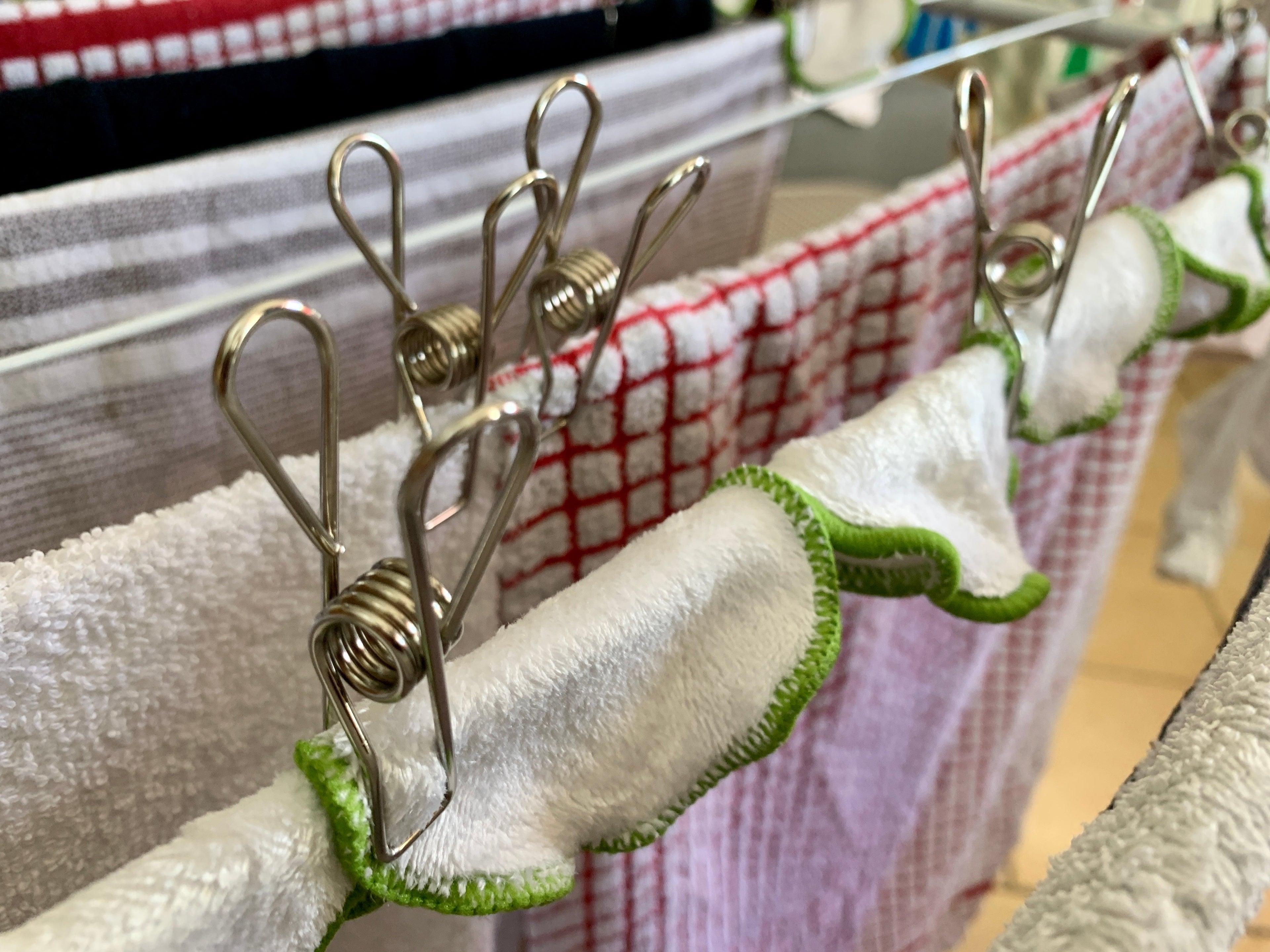 Stainless steel clothes pegs grouped together, rust resistant for outdoor use