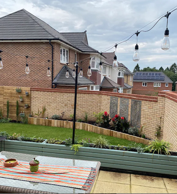 Metal festoon lighting pole supporting a string of outdoor garden lights