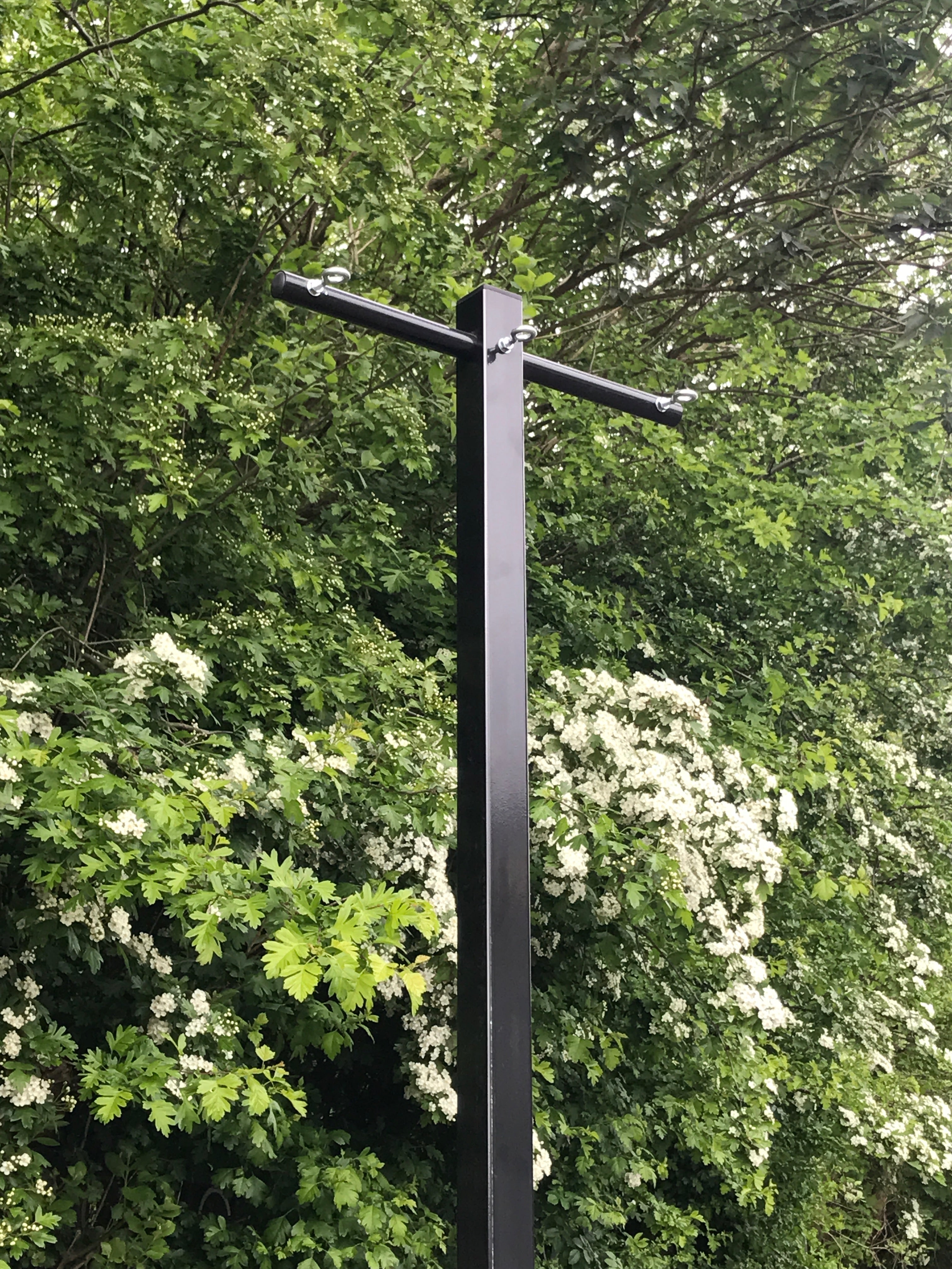 Multi-line washing line post with several drying lines strung between the arms